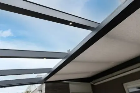 Glass veranda roof with integrated LED lighting in the rafters