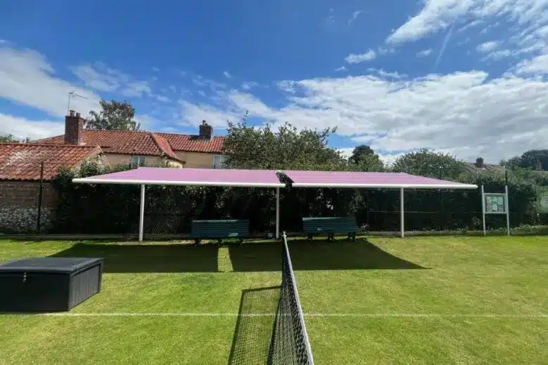 Central view of twin Weinor awnings covering seating area at South Creake Tennis Club.