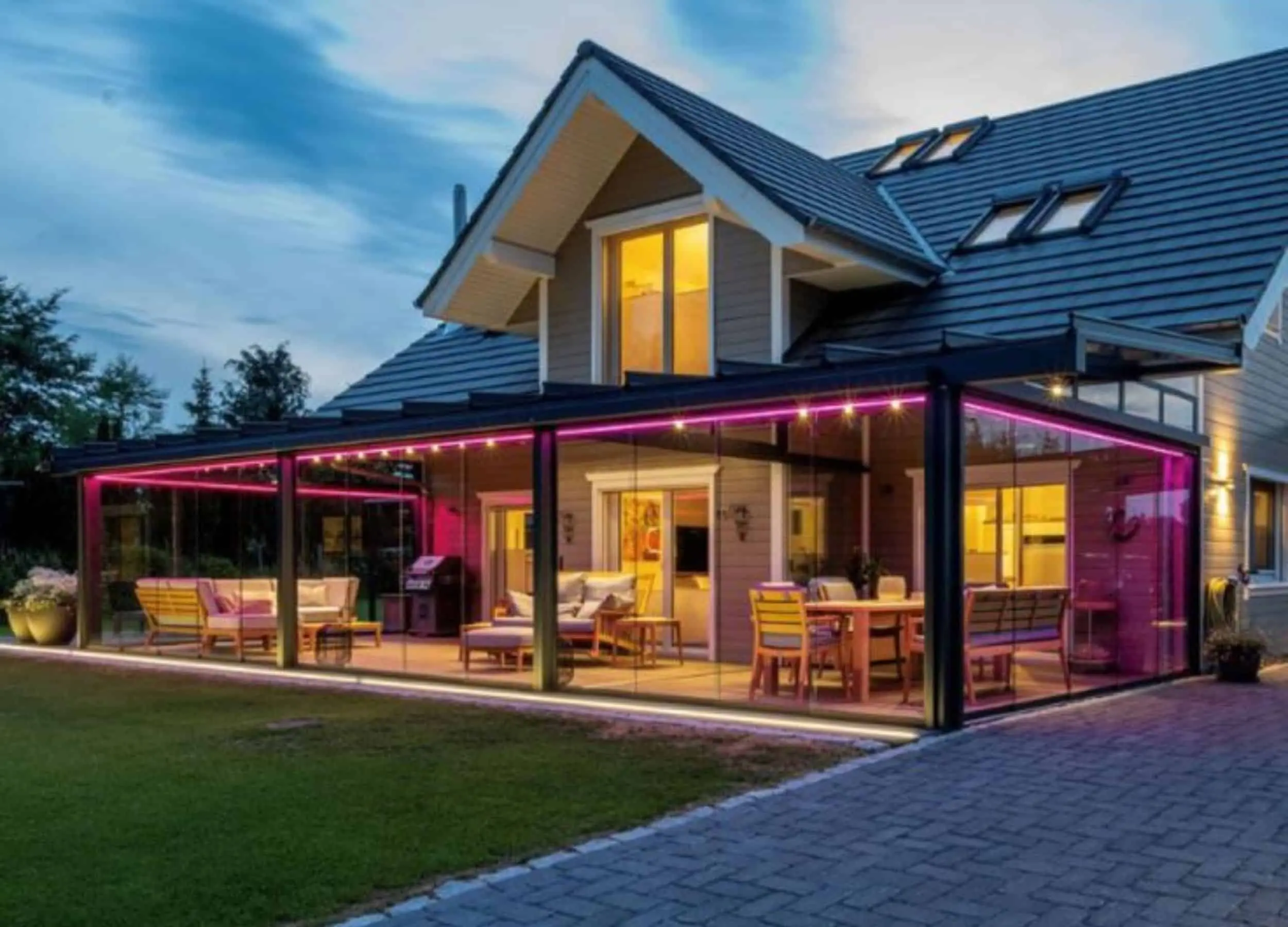 Weinor Terrazza Pure glass veranda with RGB LED lighting at night