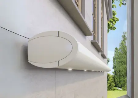 White Weinor Opal Design II LED awning on stone façade, blending classic curves with modern lighting.