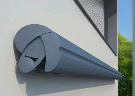 Curved semi-cassette Weinor Semina awning in anthracite, mounted on a white wall.